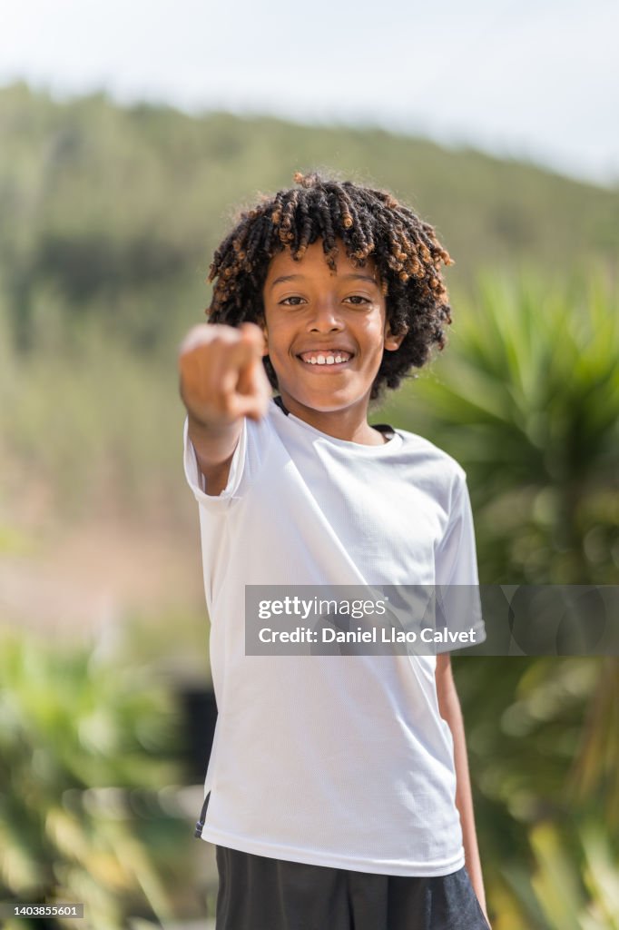 African American boy pointing at camera