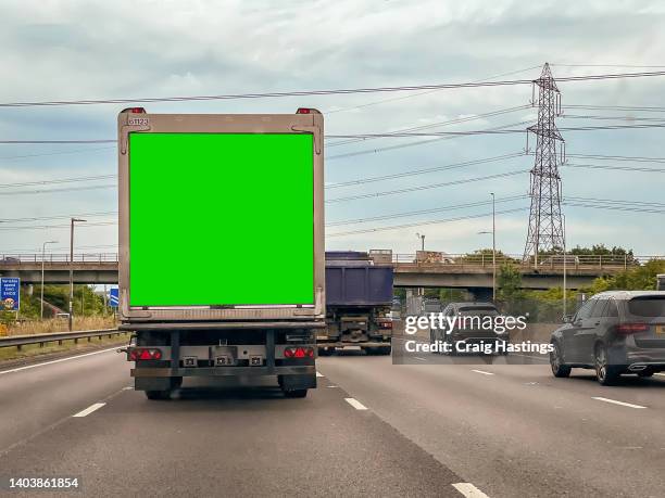 close up of truck lorry haulage vehicle on highway with green screen chroma key marketing advertisement billboard on side that can be replaced with marketing or ad agencies campaign content targeting adverts at consumers, retail shoppers, commuters - billboard truck stock-fotos und bilder