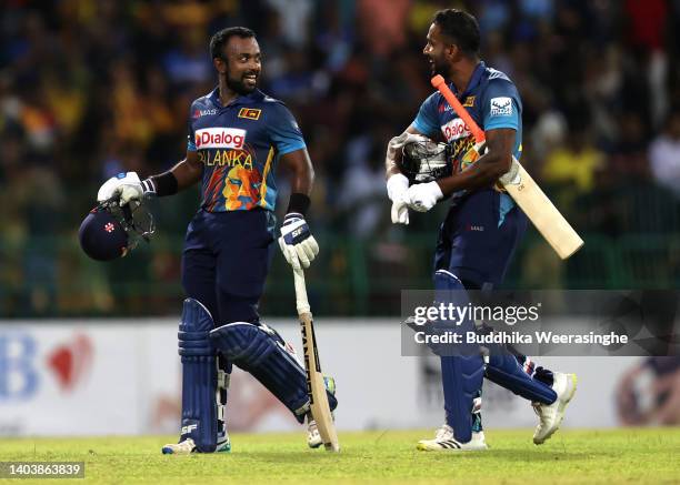 Sri Lankan batsmen Charith Asalanka and Chamika Karunaratne leave the ground after winning the match during the 3rd match in the ODI series between...