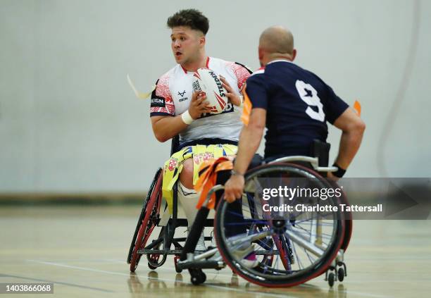 Tom Halliwell of England is challenged by Yann Verdi of France during the Wheelchair Rugby League International Friendly match between England and...