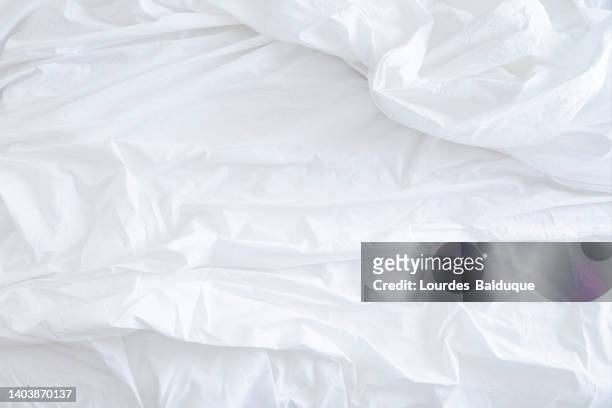 white sheet on the bed - sheets stockfoto's en -beelden