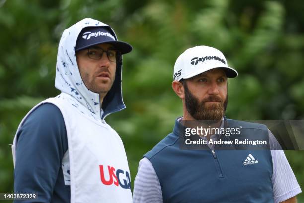 Dustin Johnson of the United States and caddie Austin Johnson wait on the fifth tee during the final round of the 122nd U.S. Open Championship at The...