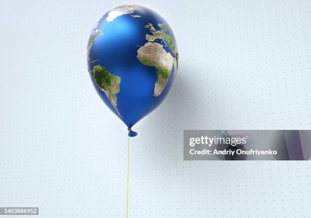 flying helium balloon world map - all the money in the world stock-fotos und bilder