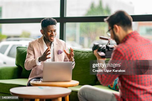 african vlogger video shooting with cameramen - camera man stock pictures, royalty-free photos & images