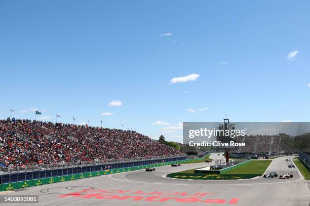 General view of the action as George Russell of Great Britain driving the Mercedes AMG Petronas F1 Team W13 and Kevin Magnussen of Denmark driving...