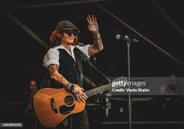 Johnny Depp performs on stage with Jeff Beck during the Helsinki Blues Festival at Kaisaniemen Puisto on June 19, 2022 in Helsinki, Finland.