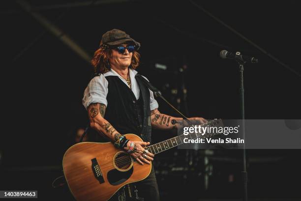 Johnny Depp performs on stage with Jeff Beck during the Helsinki Blues Festival at Kaisaniemen Puisto on June 19, 2022 in Helsinki, Finland.