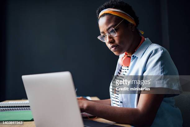 university student working on a school project in the library - person of colour stock pictures, royalty-free photos & images
