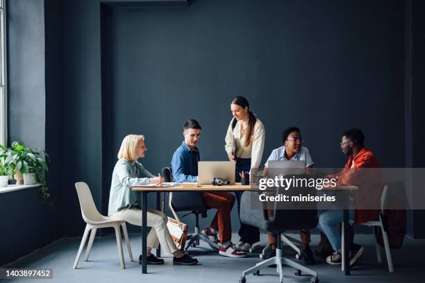 five friends studying together in the library - post secondary education stock pictures, royalty-free photos & images