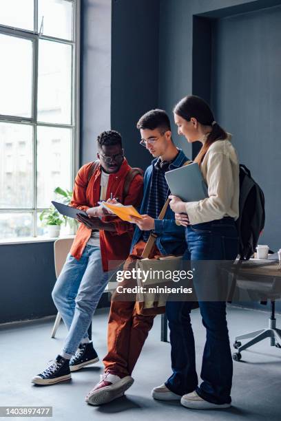 three friends studying together in the library - digital campus stock pictures, royalty-free photos & images