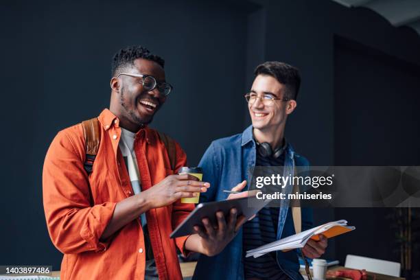 two happy friends talking in the library - friendship males bildbanksfoton och bilder