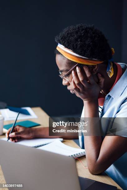 young woman studying in the library - lecture hall dark stock pictures, royalty-free photos & images