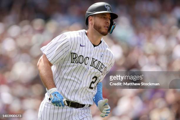Cron of the Colorado Rockies runs to first base after hitting a RBI single against the San Diego Padres in the fifth inning at Coors Field on June...