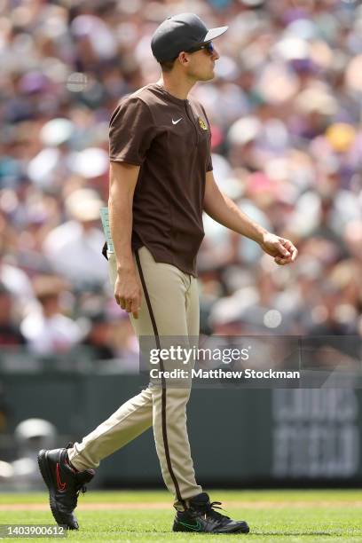 Acting manager Ryan Flaherty of the San Diego Padres walks to the mound to change pitchers against the Colorado Rockies in the fifth inning at Coors...