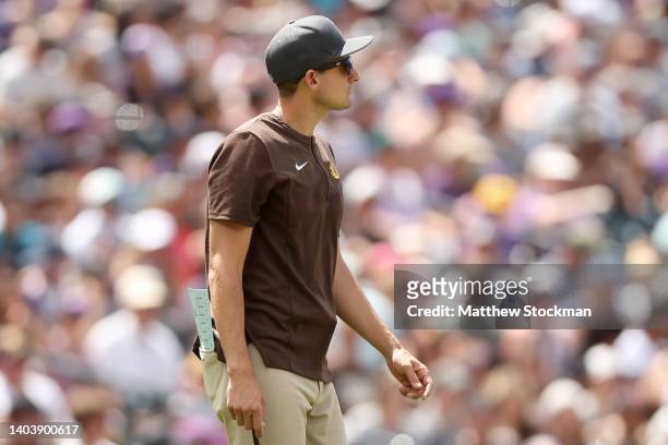 Acting manager Ryan Flaherty of the San Diego Padres walks to the mound to change pitchers against the Colorado Rockies in the fifth inning at Coors...