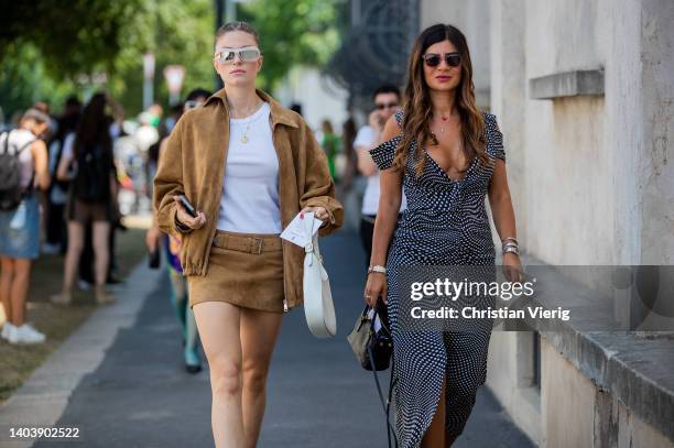 Guest is seen wearing brown jacket, skirt, white bag, sunglasses outside Prada of during Milan Fashion Week S/S 2023 on June 19, 2022 in Milan, Italy.