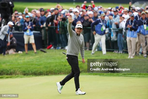 Keegan Bradley of the United States waves on the 18th green during the final round of the 122nd U.S. Open Championship at The Country Club on June...
