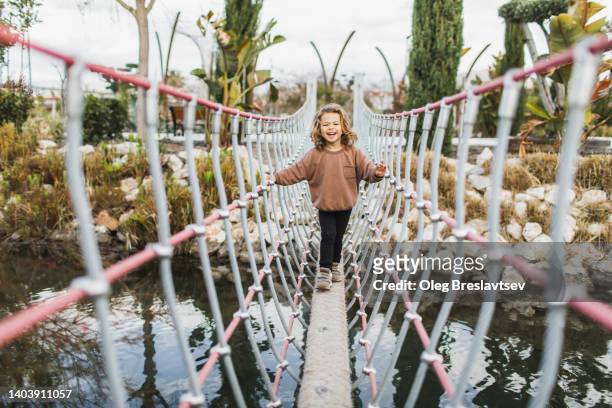 88 Young Girl Walking Across Single Rope Bridge Stock Photos, High