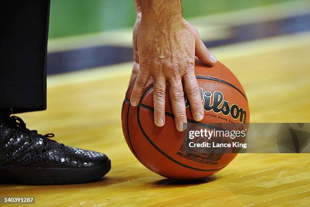 Referee picks up the game ball during a game against the Georgia Tech Yellow Jackets and the North Carolina Tar Heels during the first half of the...