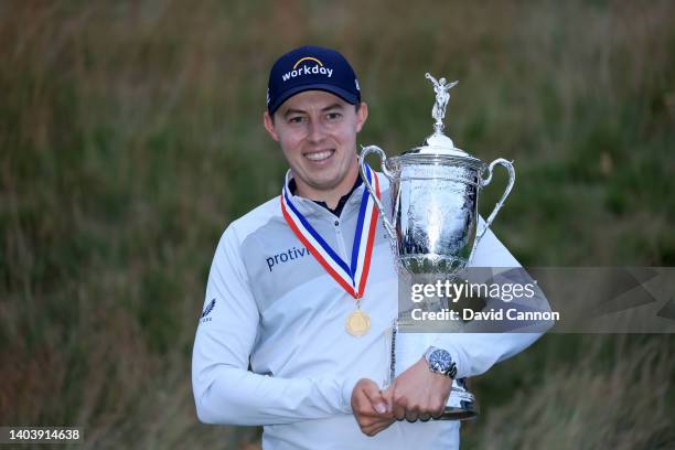 Matthew Fitzpatrick of England holds the trophy after his one shot victory in the final round of the 2022 U.S.Open at The Country Club on June 19,...