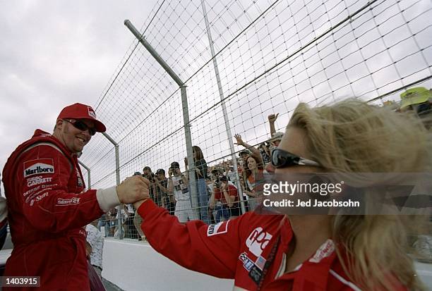 Paul Tracy of Canada is greeted by Lisa Hunter at the Motorola 300 at the Gateway International Raceway in Madison, Illinois.