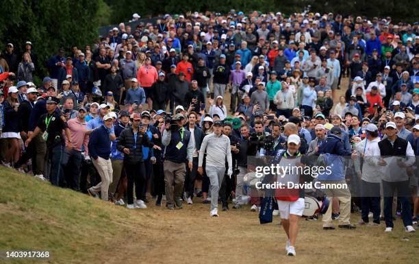 Matthew Fitzpatrick of England plays his second shot on the 15th hole in front of a huge gallery during the final round of the 2022 U.S.Open at The...