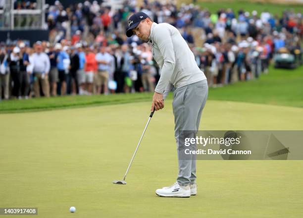 Matthew Fitzpatrick of England holes a putt for a birdie on the 15th hole in front of a huge gallery during the final round of the 2022 U.S.Open at...