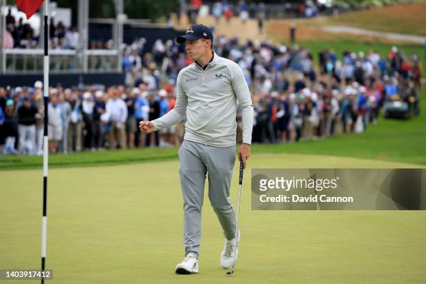 Matthew Fitzpatrick of England holes a putt for a birdie on the 15th hole in front of a huge gallery during the final round of the 2022 U.S.Open at...