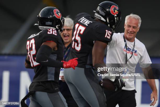 Donald Payne of the Houston Gamblers celebrates scoring a touchdown with Micah Abernathy and Daryl Johnston, Executive Vice President of USFL...