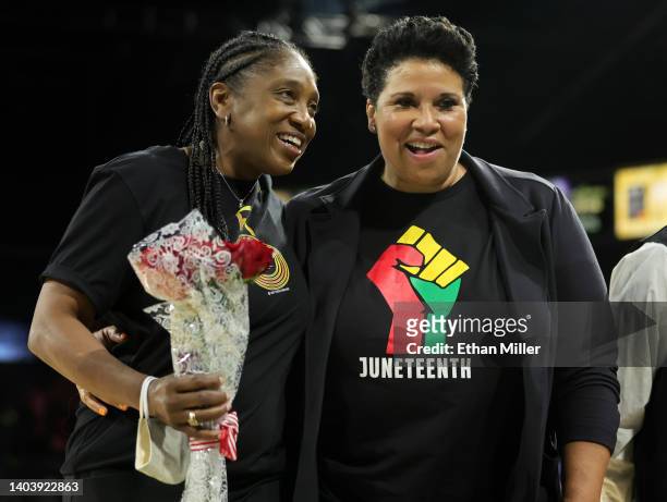Women's Basketball Hall of Fame member and four-time Olympic gold medalist Teresa Edwards walks off the court holding flowers with general manager...