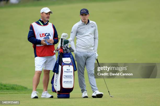 Matthew Fitzpatrick of England prepares to play his third shot on the 14th hole with his caddie Billy Foster during the final round of the 2022...