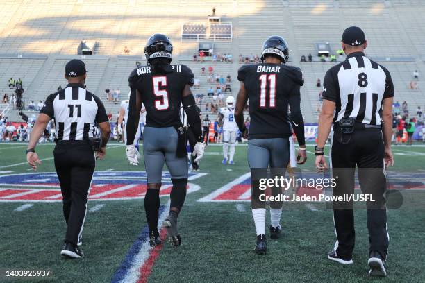 Reggie Northrup and Kenji Bahar of the Houston Gamblers walk to center field with two referees for the coin toss before the game against the New...