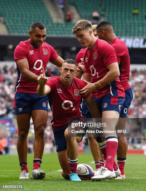 Jonny May of England celebrates scoring his sides 2nd try with Joe Marchant and Tommy Freeman during the International match between England and...