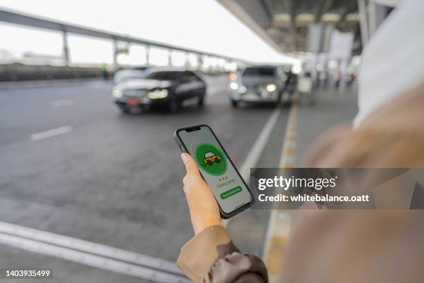 muslim business waiting for uber taxi at outside airport. - uber stockfoto's en -beelden