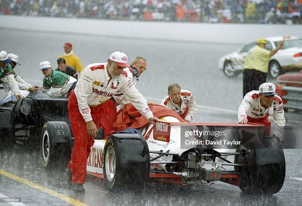 The crew moves a car during a rain delay at the Indianapolis 500 at