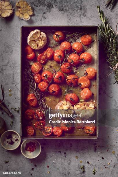 owen baked  pachino tomatos with garlic and herbs - red salvia stock pictures, royalty-free photos & images