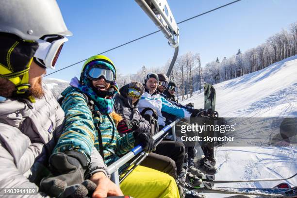 young happy friends on a ski lift in winter day. - happy skier stockfoto's en -beelden