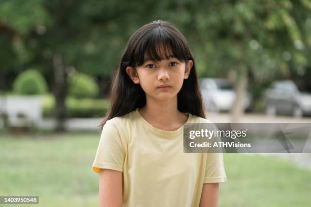 portrait sad school tween girl looking to the camera. insult themselves - jj girls stock pictures, royalty-free photos & images