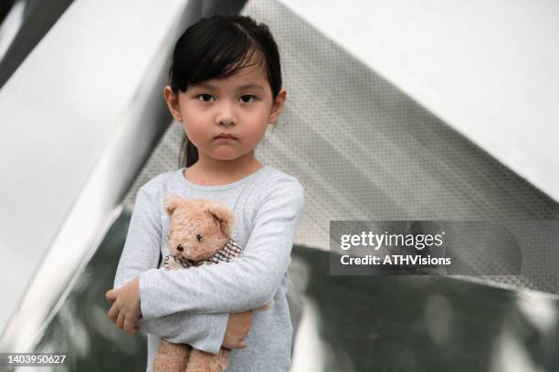 portraits depression and apathetic toddler girl holding teddy bear. 
insult themselves - child abuse 個照片及圖片檔