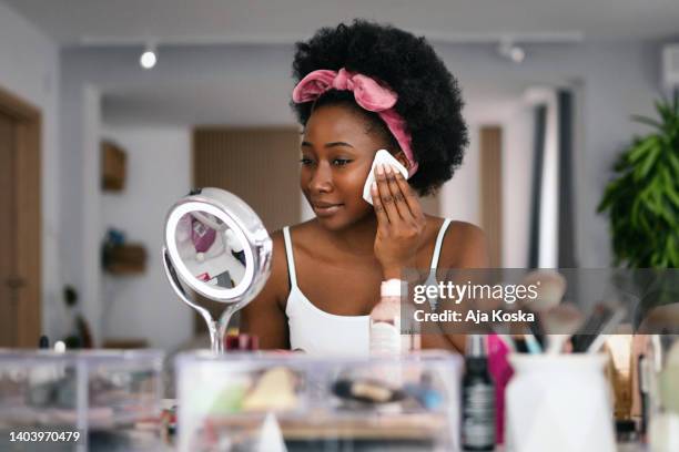 beautiful woman cleaning her face with a face cloth. - dressing table stock pictures, royalty-free photos & images