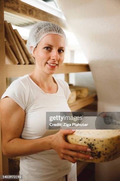 happy woman worker holding the cheese she made - cheese making stock pictures, royalty-free photos & images