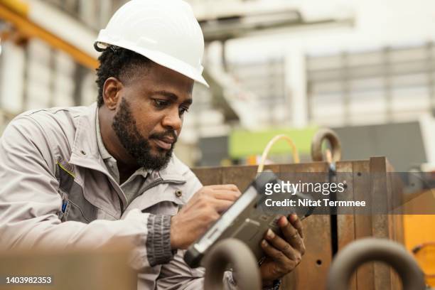 move toward data driven predictive maintenance in manufacturing industry. maintenance engineer using a digital tablet in mold storage area to checking based on period to ensure that tools are regularly monitored and maintained in production cycle. - measuring potential business stock pictures, royalty-free photos & images