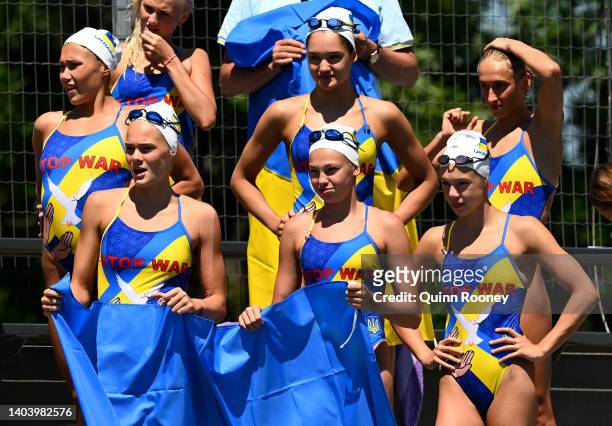 Members of Team Ukraine cheer on Marta Fiedina as she competes in the Artistic Swimming Women's Solo Free Preliminaries on day four of the Budapest...