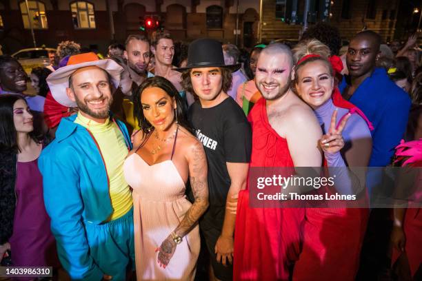 Choreograph Alexander Kruska , Gina Lisa Lohfink , designer Samuel Gaertner stand with the models after the show on the bridge 'Eiserner Steg' at the...