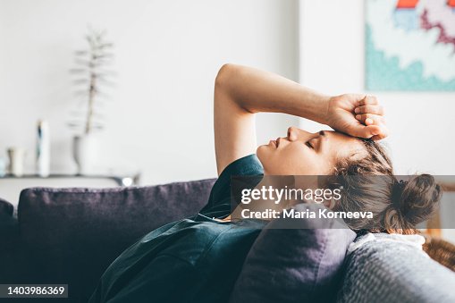 Sad and depressed woman sitting on sofa at home. Sad and depressed woman sitting on sofa at home.