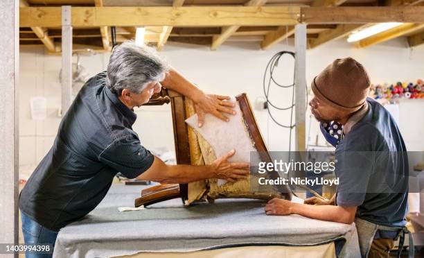 two upholstery workers working in workshop - upholstered furniture stock pictures, royalty-free photos & images
