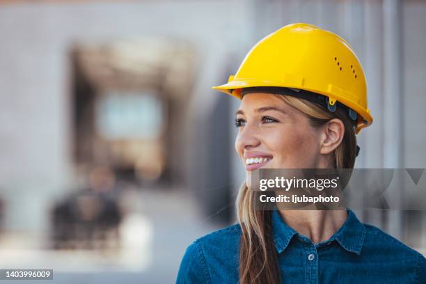 female construction worker in close-up - headwear stock pictures, royalty-free photos & images