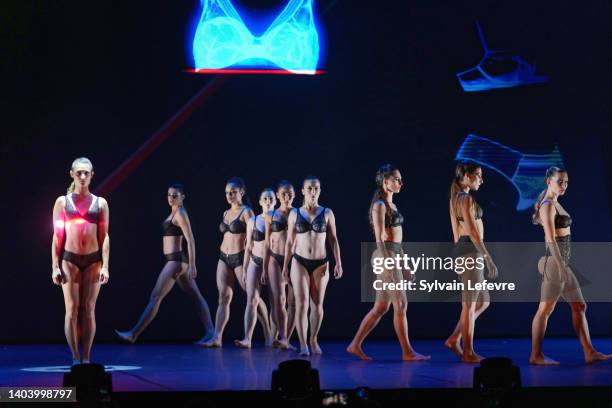 Models perform live on stage during the "Retrofutur" Lingerie and Fashion show as part of Salon International de la Lingerie at Theatre Marigny on...