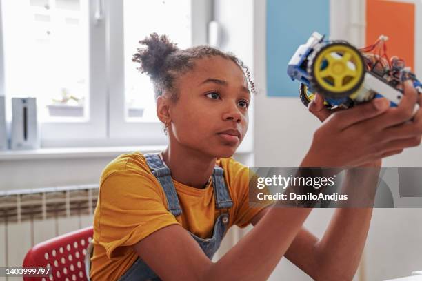 cute girl with afro hair at the stem class - stem topic stock pictures, royalty-free photos & images