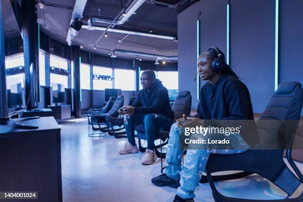 two black teenagers in a esports gaming cafe - massively multiplayer online game stock pictures, royalty-free photos & images